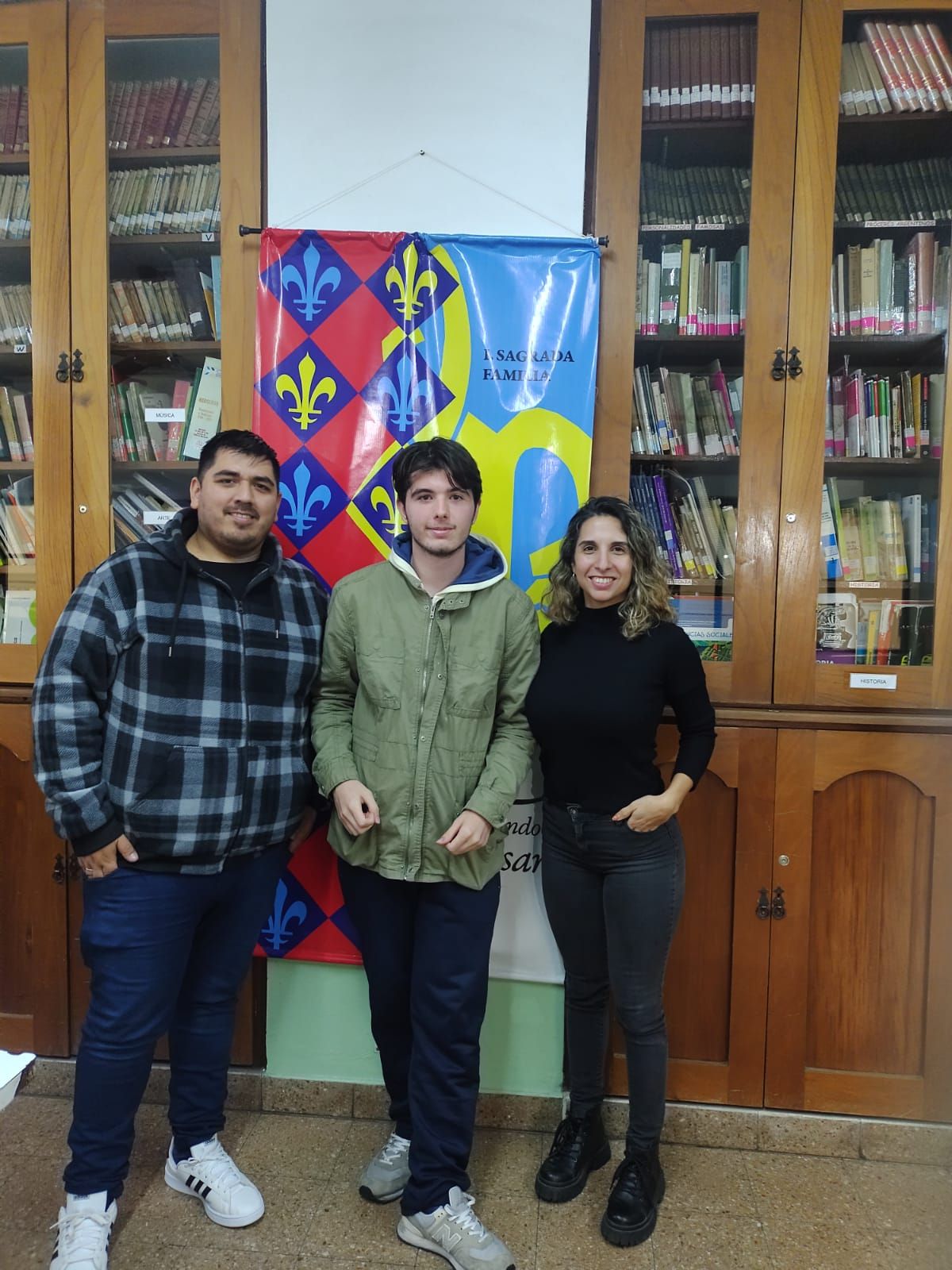 El estudiante de Banfield junto a dos de sus docentes.